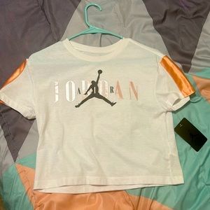 I AM SELLING THIS WHITE AND CORAL JORDAN SHIRT FOR 25!! THE ORIGINAL COST WAS 30